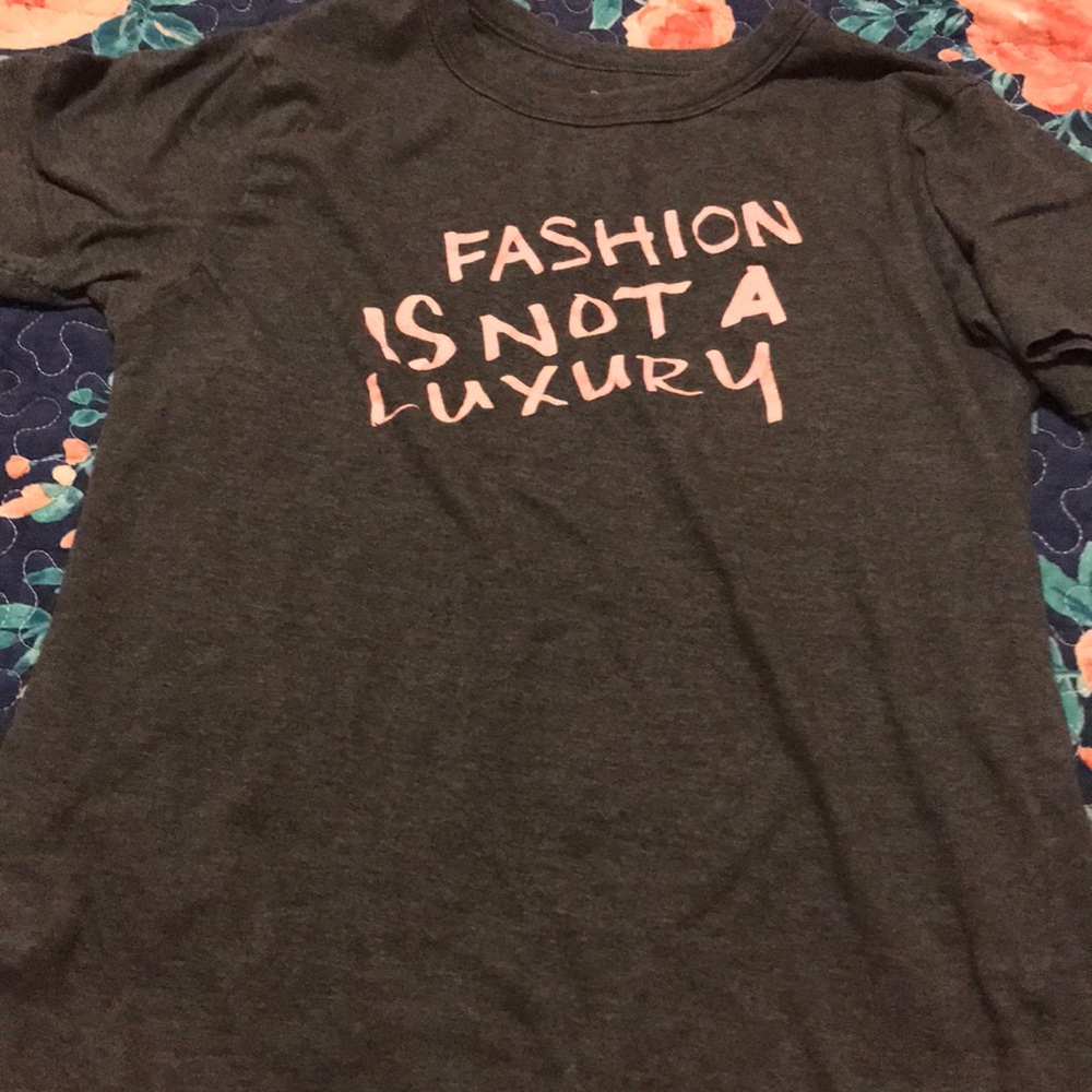 A grey shirt with pink lettering